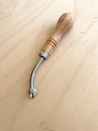 A leathercraft tool called an adjustable edge creaser