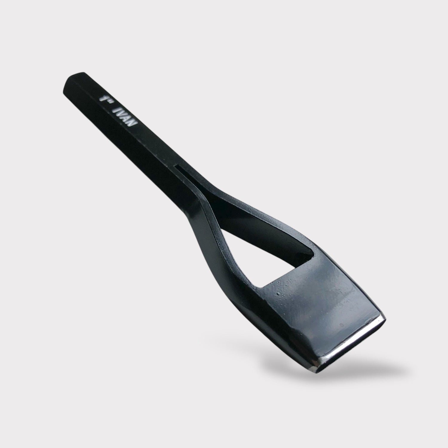 A black solid looking oblong slot punch for leathercraft