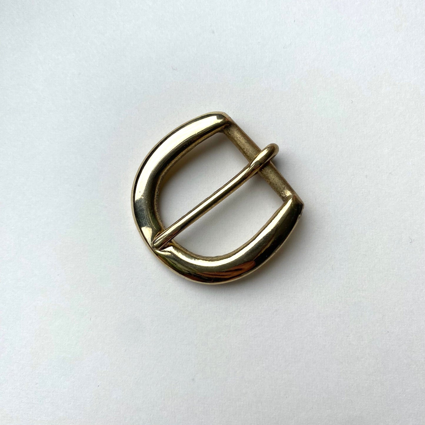 Gold metal buckle on a white background