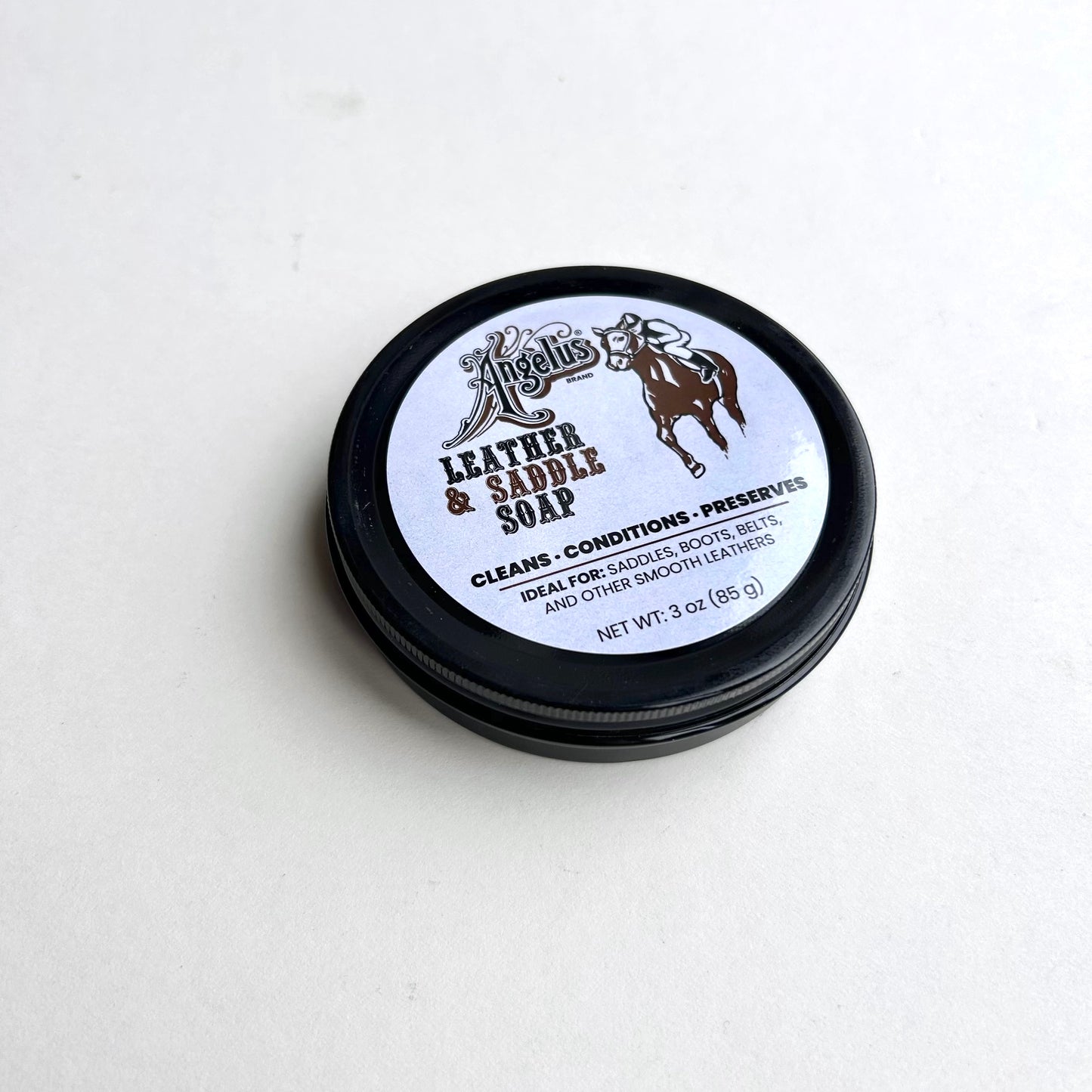 Leather and saddle soap container on a white background