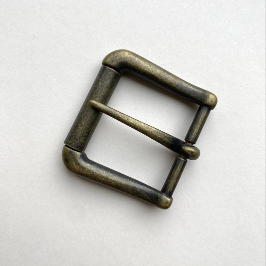 Bronze belt buckle on a white background