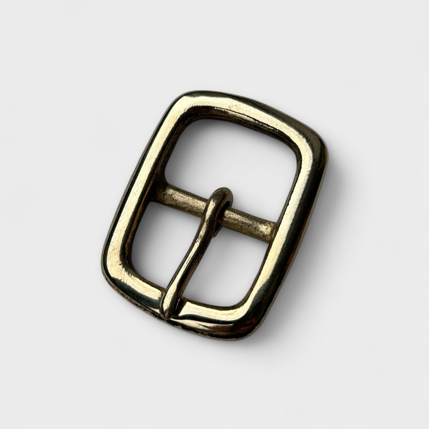 Brass belt buckle on a white background