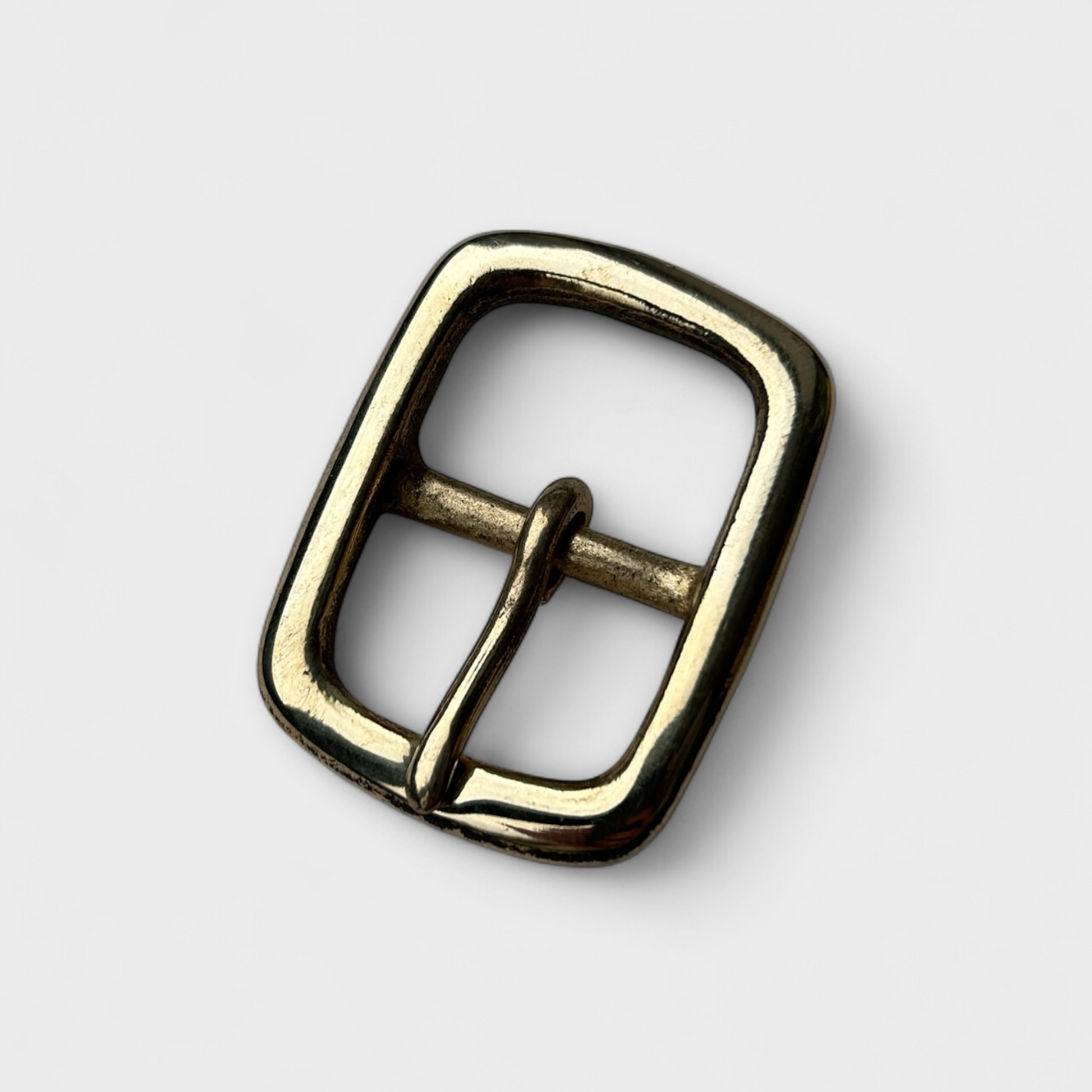 Brass belt buckle on a white background