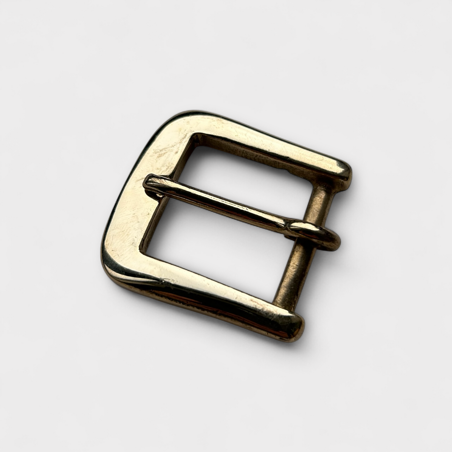 Gold metal buckle on a white background
