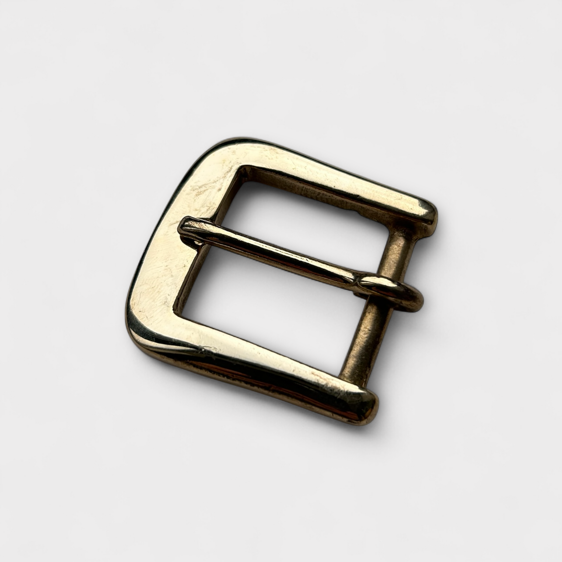 Gold metal buckle on a white background