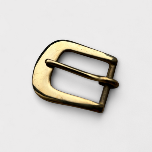 Gold belt buckle on a light gray background