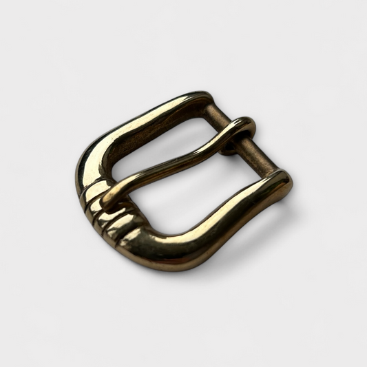 Gold metal buckle on a white background
