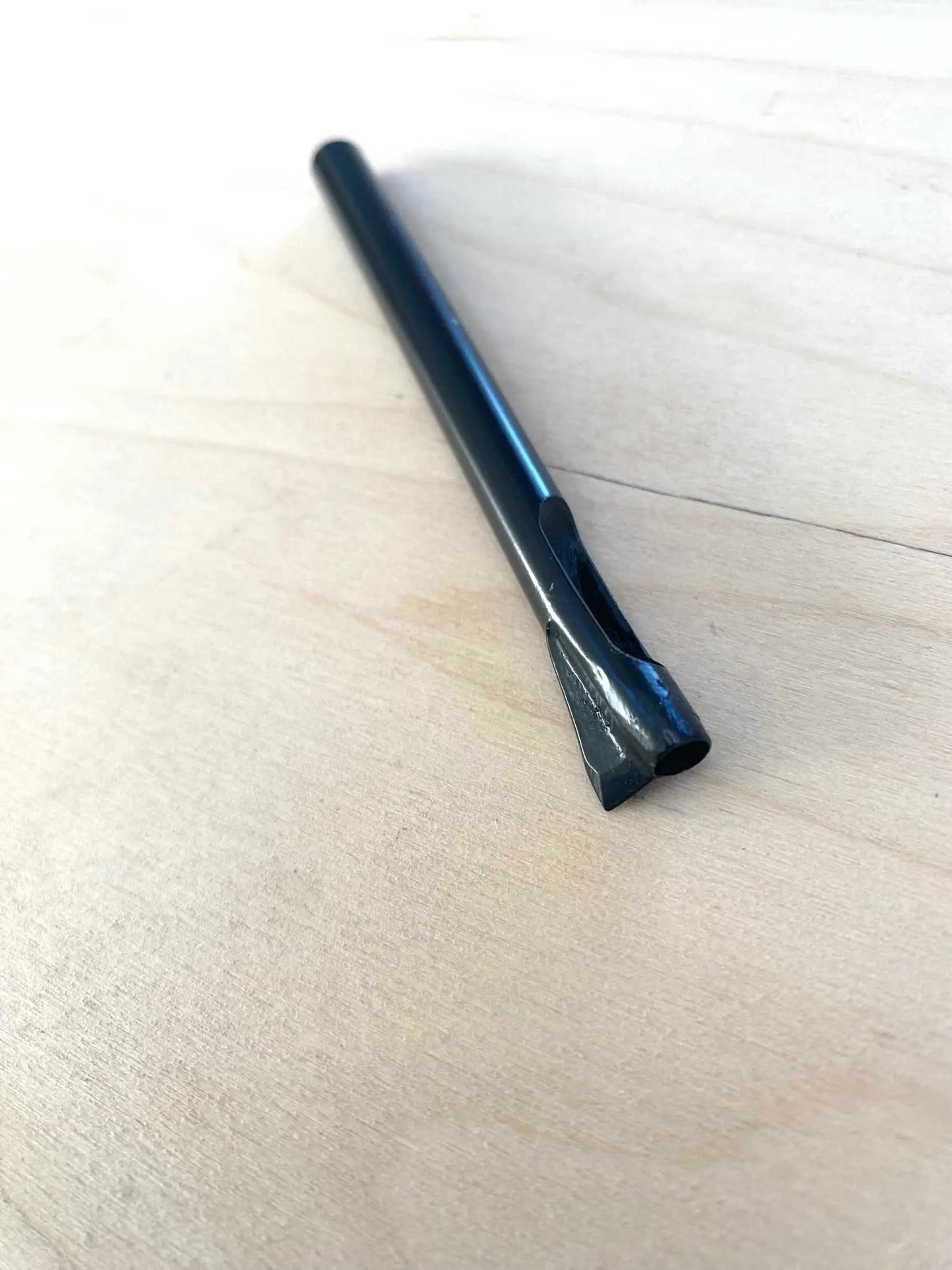 Sam Browne Leather Button Hole Punch on wooden surface, 5mm size.