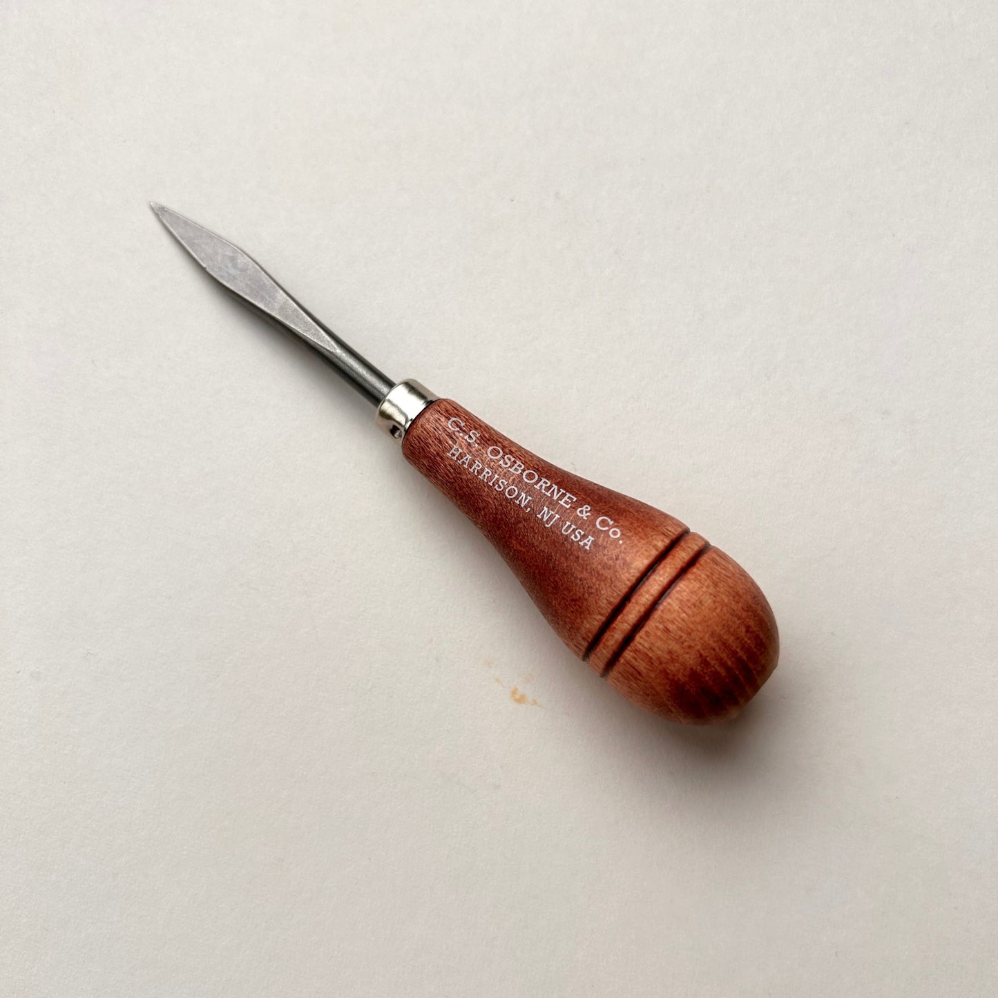 CS Osborne wooden-handled belt awl on a white background