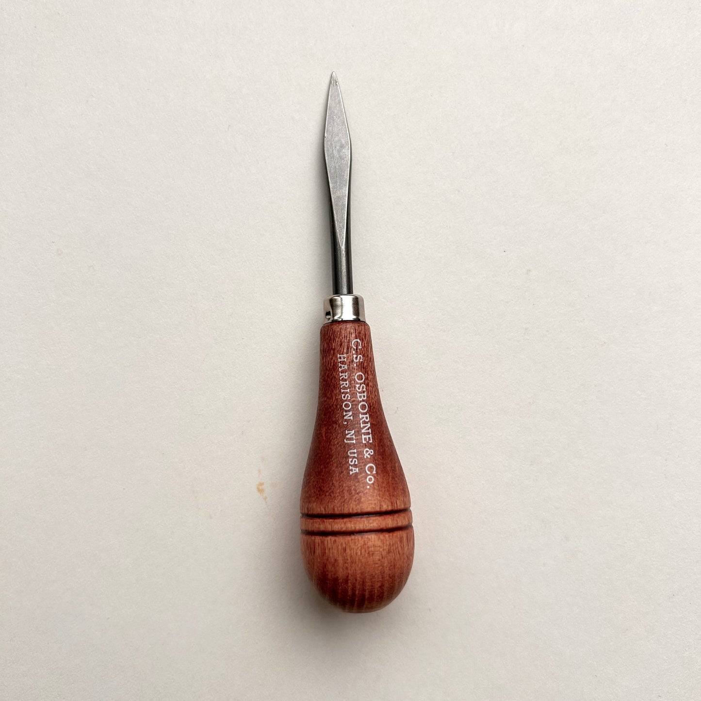 CS Osborne wooden-handled belt awl on a white background
