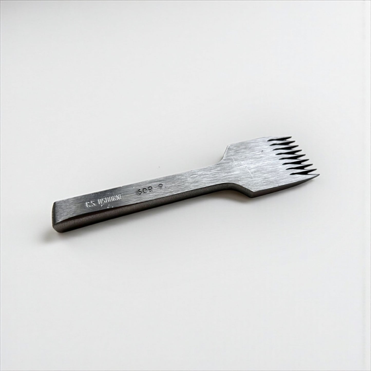 CS Osborne steel leather pricking irons metal tool with teeth on a white background