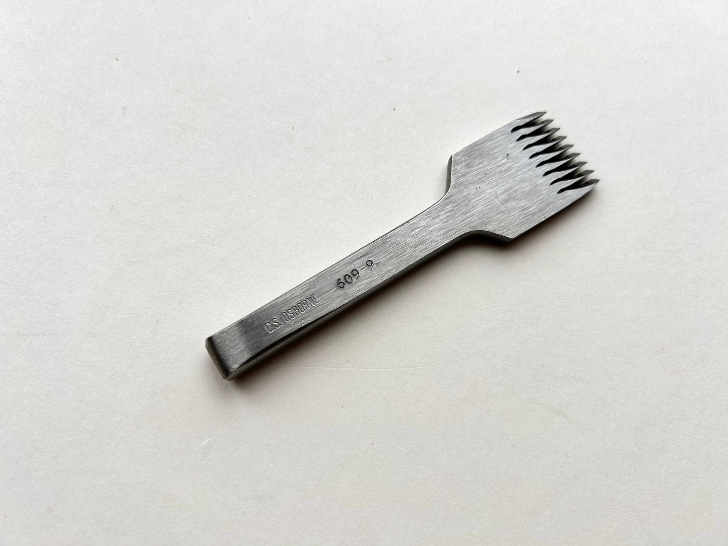 CS Osborne steel leather pricking irons metal tool with teeth on a white background