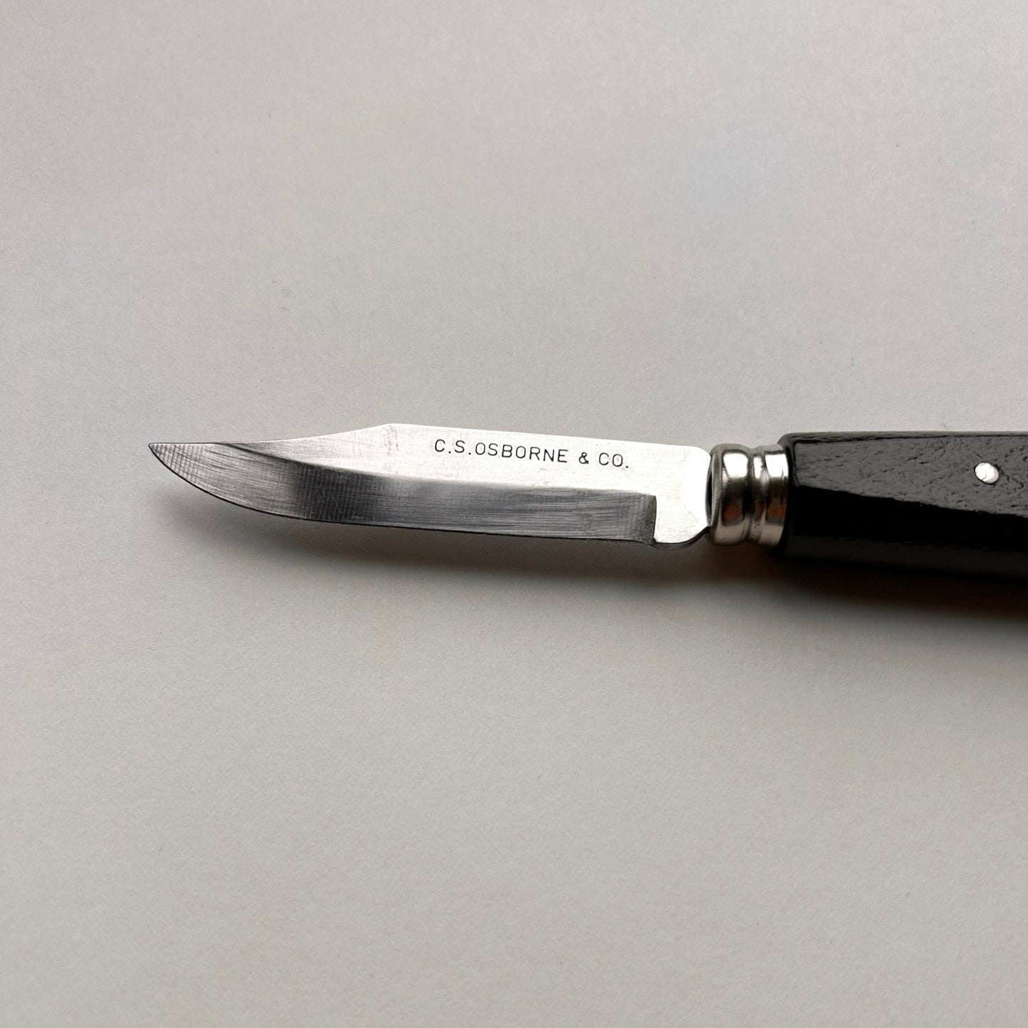 Pocket knife with a wooden handle on a gray background