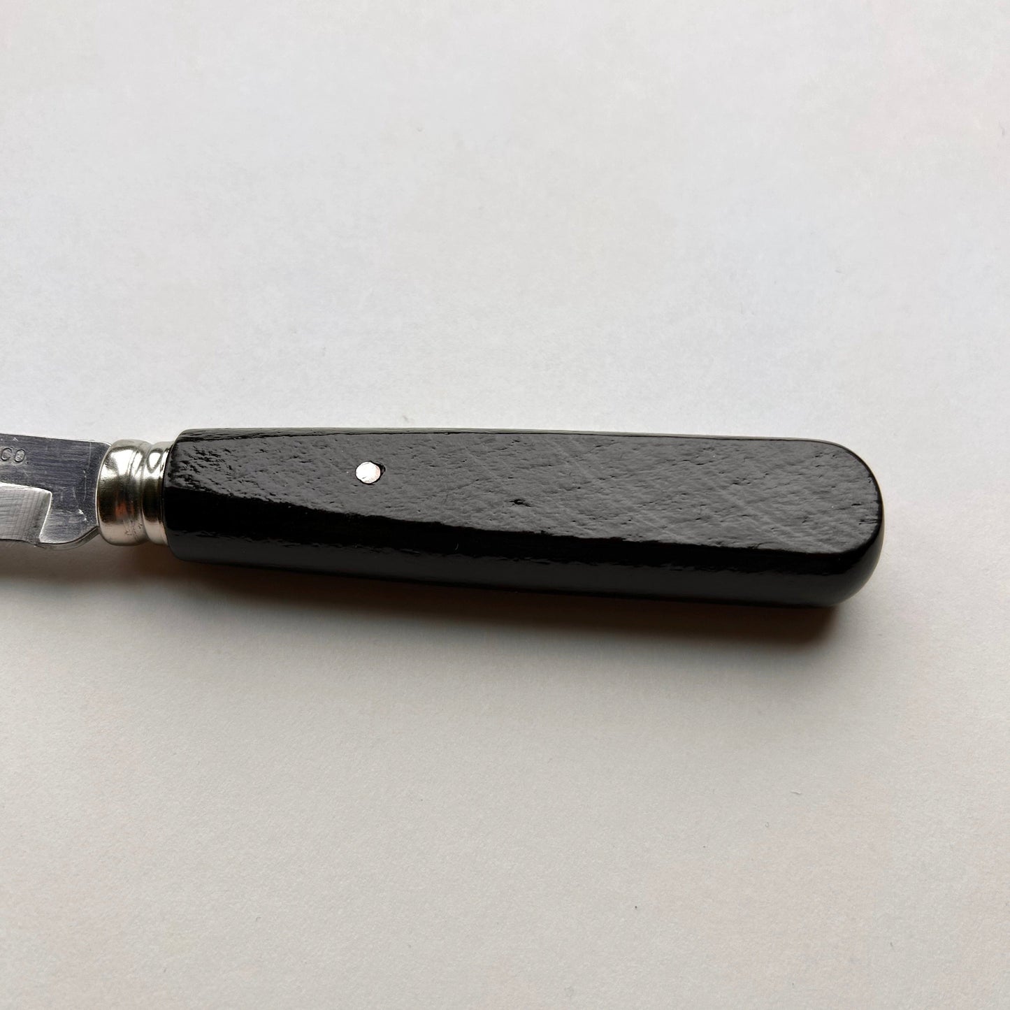Knife with a black handle on a white background