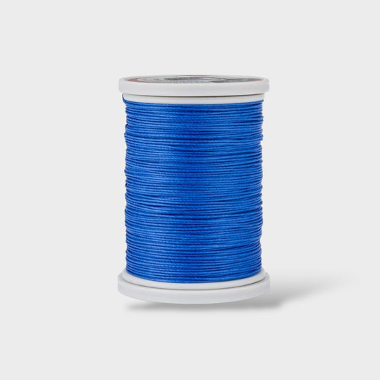 Spool of blue thread on a white background