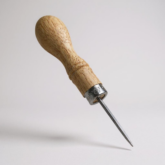 Wooden-handled leather stitching awl with metal tip on a light grey background