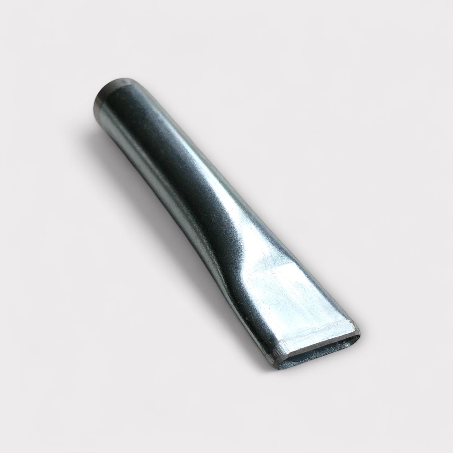Silver coloured leather belt slot punch tool on white background.