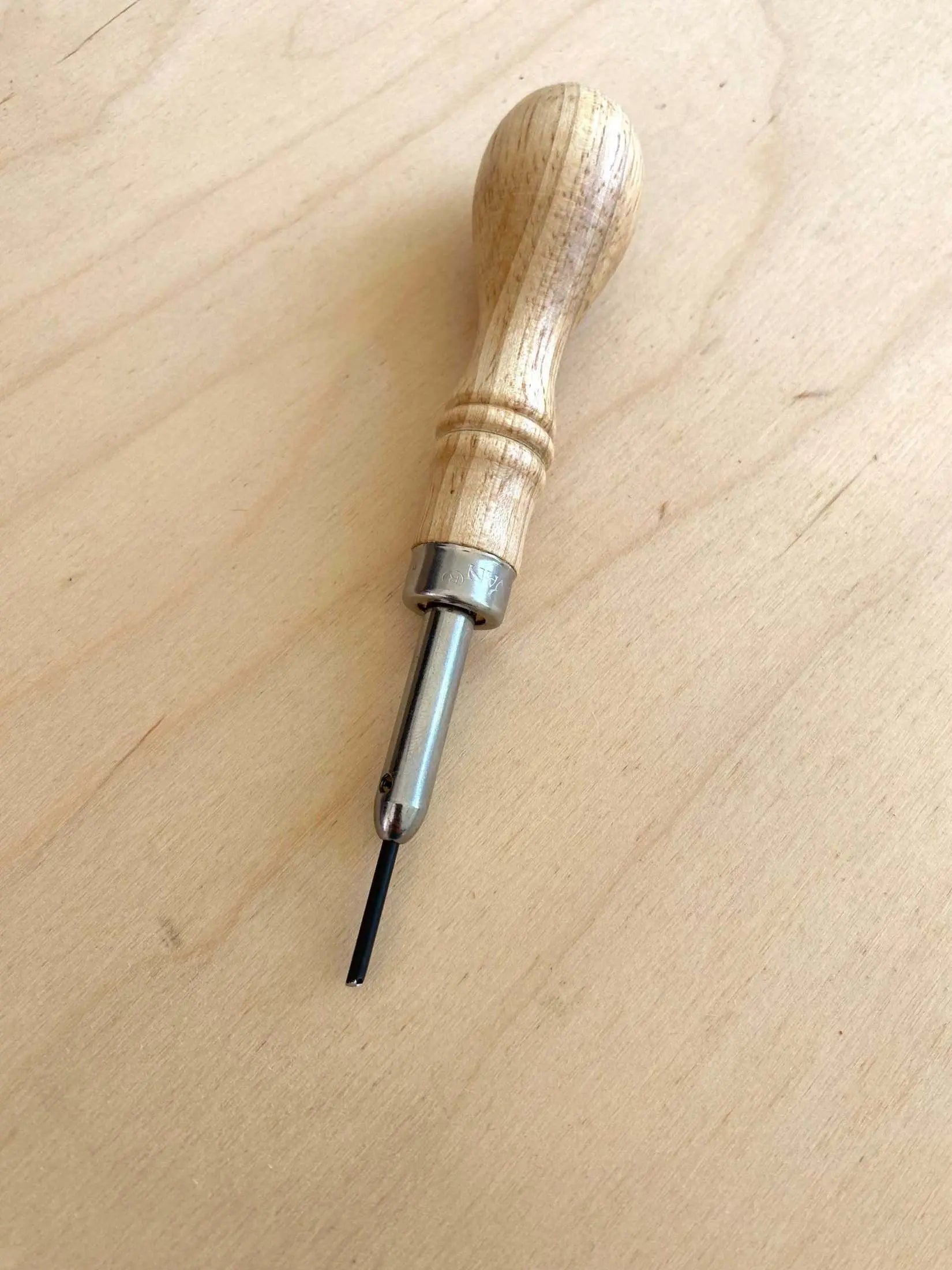 Free Hand Leather Stitch Groover Awl with ergonomic wooden handle for leathercraft precision.