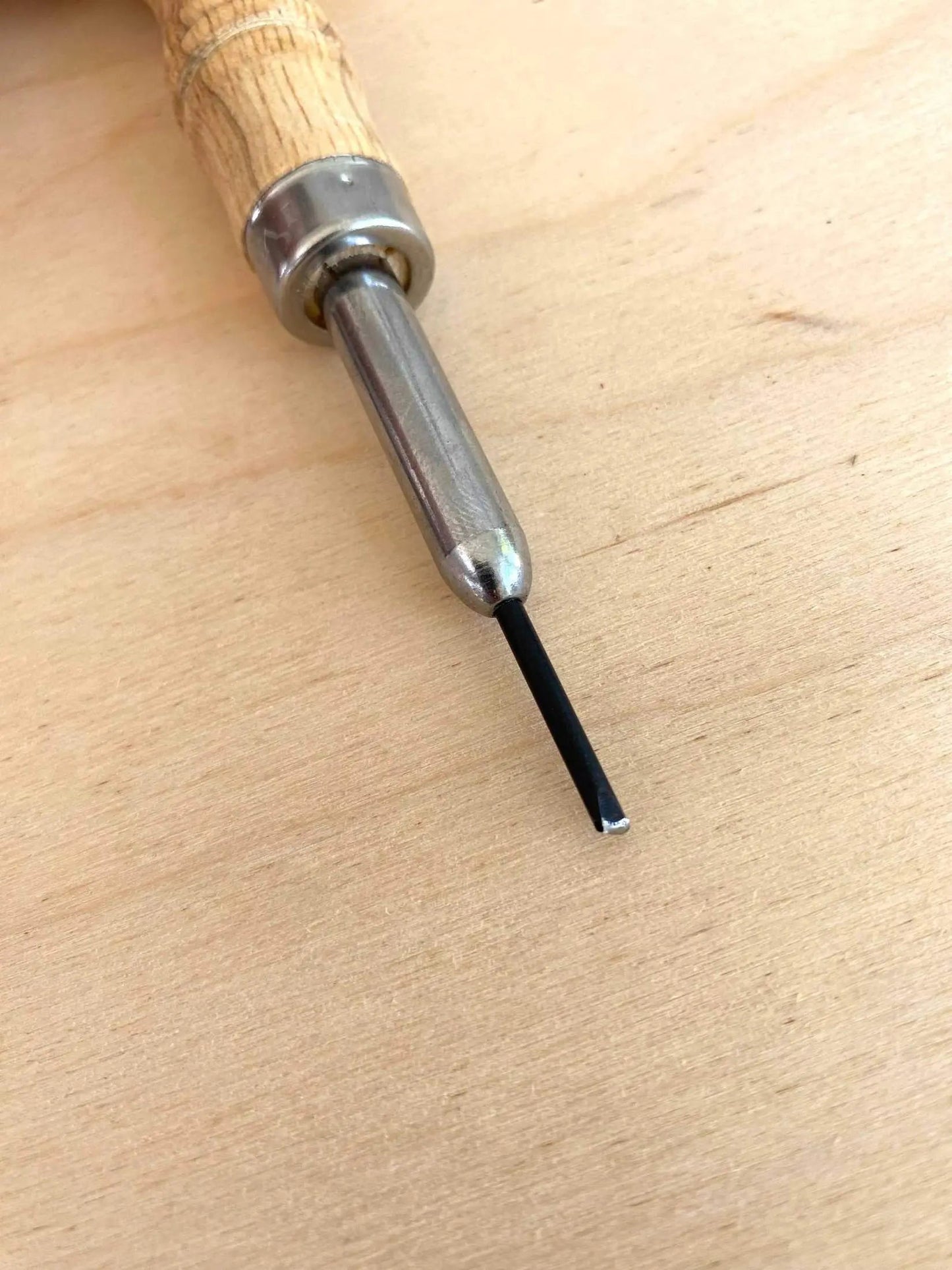 Free Hand Leather Stitch Groover Awl with wooden handle and metal blade for leathercraft projects.