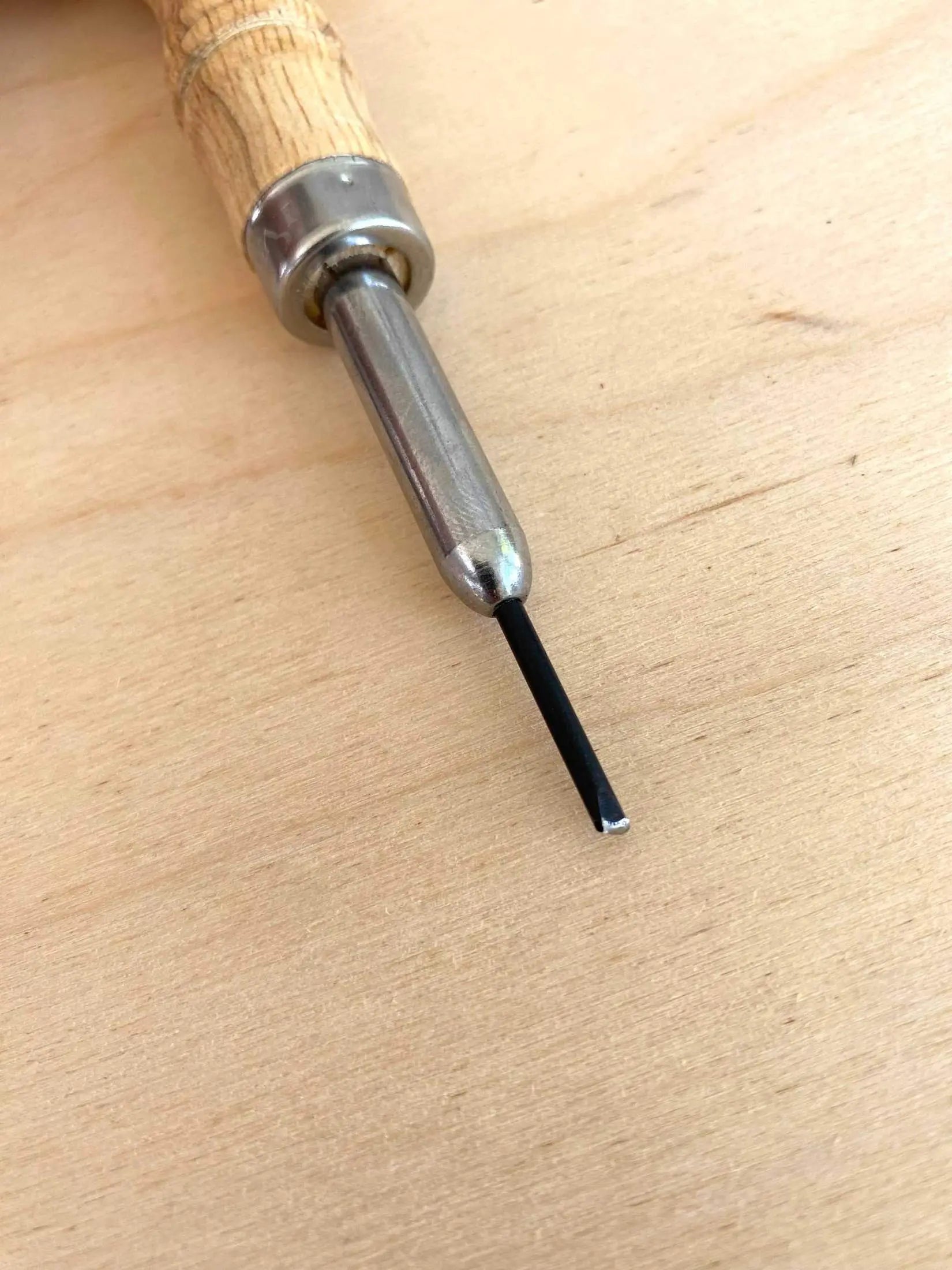 Free Hand Leather Stitch Groover Awl with wooden handle and metal blade for leathercraft projects.