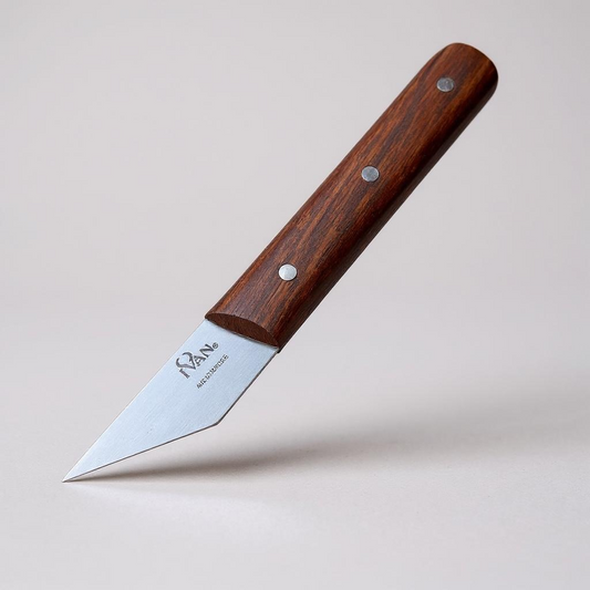 Leather skiving knife with a wooden handle on a beige background