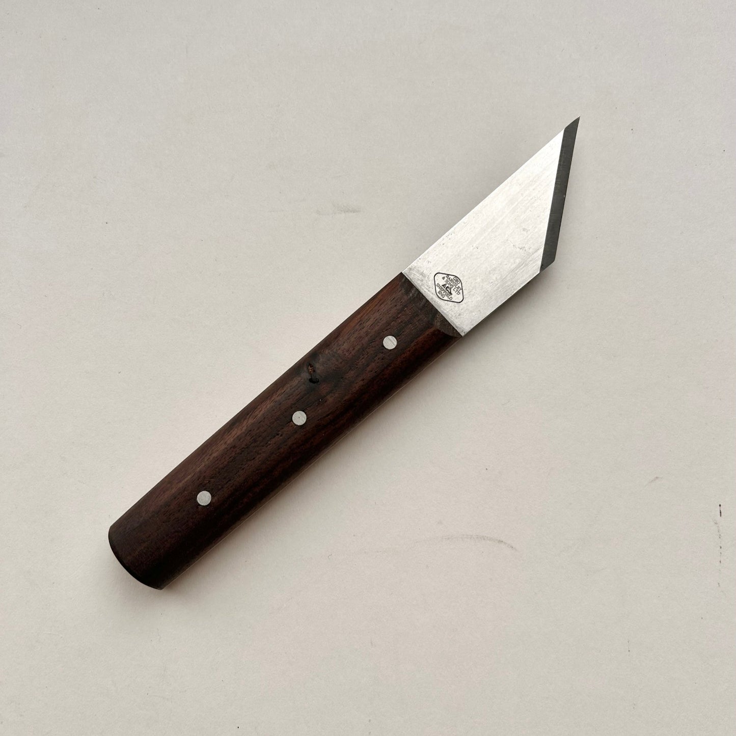 Knife with a wooden handle on a light gray background