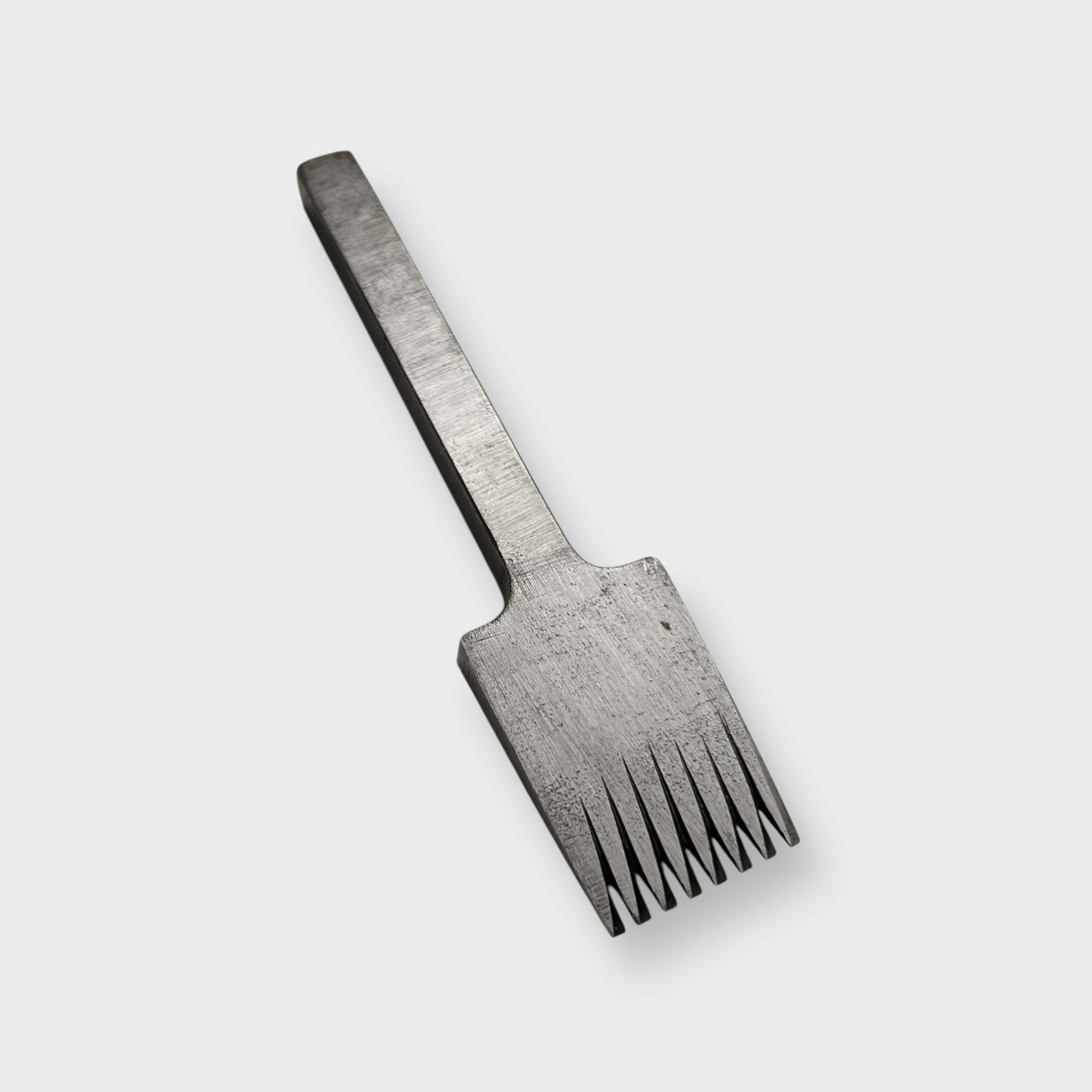 Metallic pricking iron leather tool with 'JOSEPH DIXON' engraving on a light gray background.