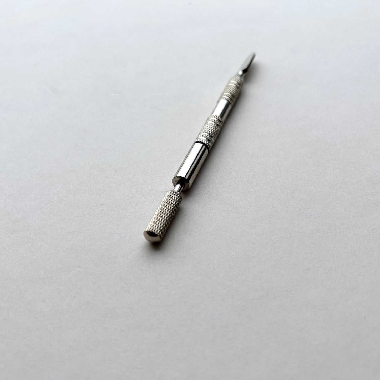 Two metallic leather edge dye pen tools with decorative patterns on a white background