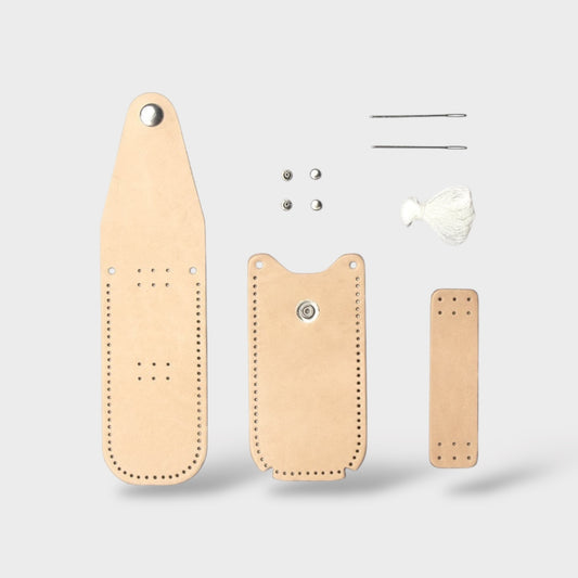 Set of leather pieces to make a knife pouch including a long strip, two smaller pieces, and a tool on a light gray background