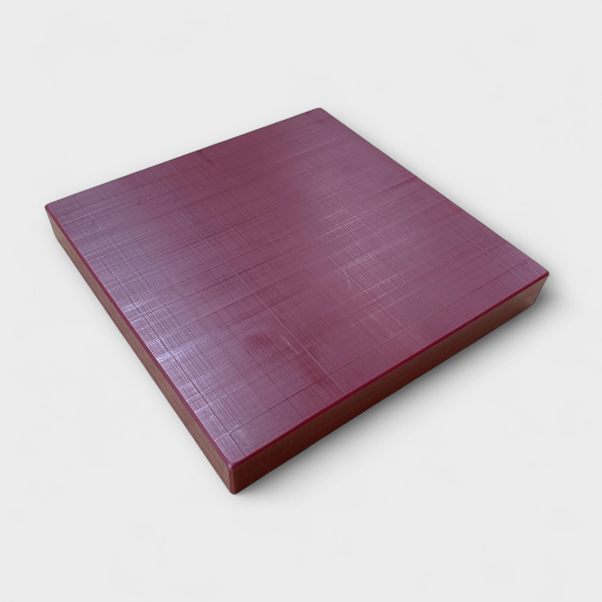 Leather punching and cutting board on white background.