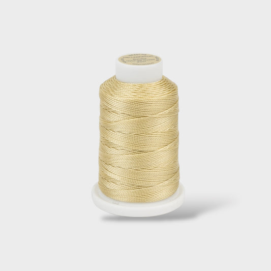 Spool of beige thread on a white background