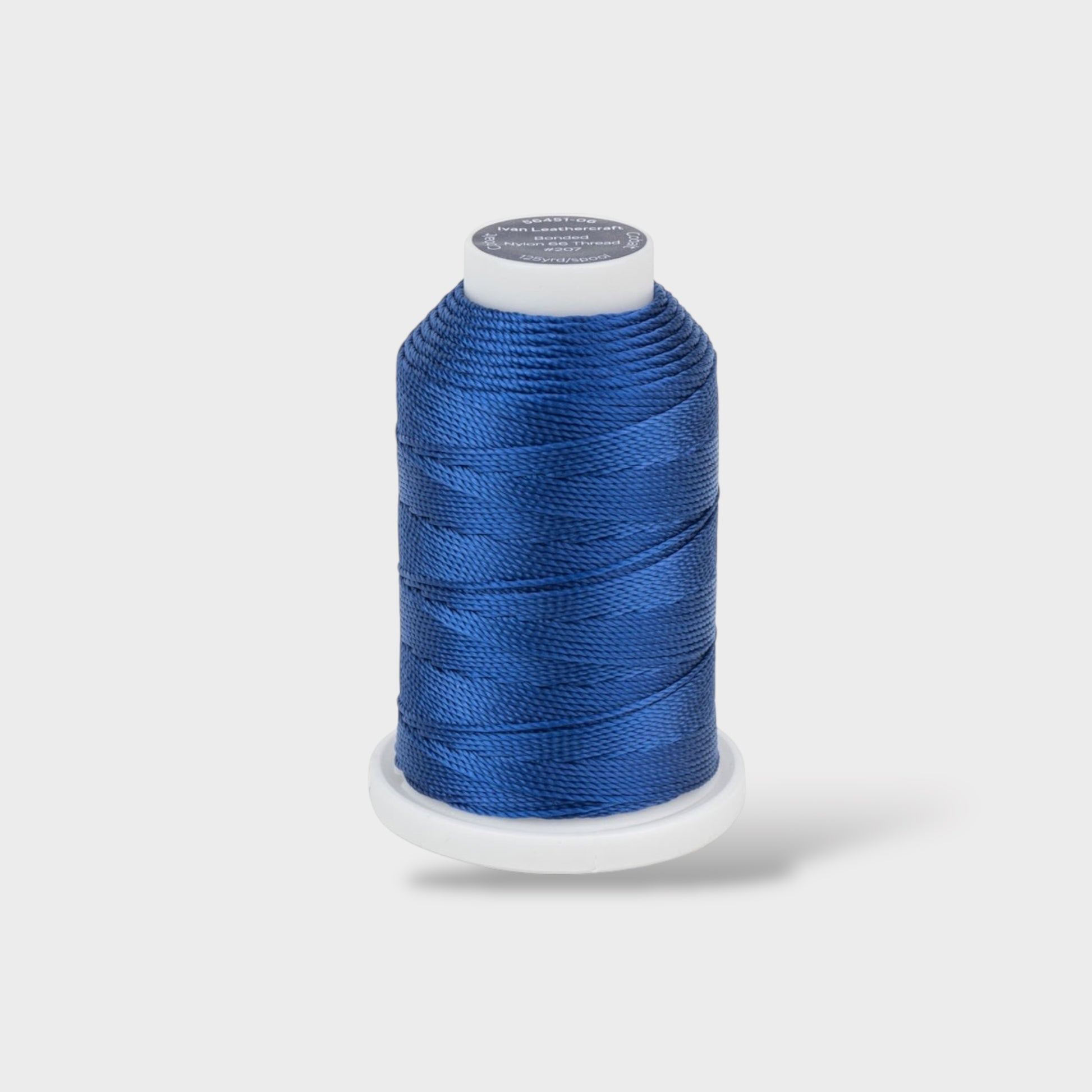 Blue spool of thread on a white background