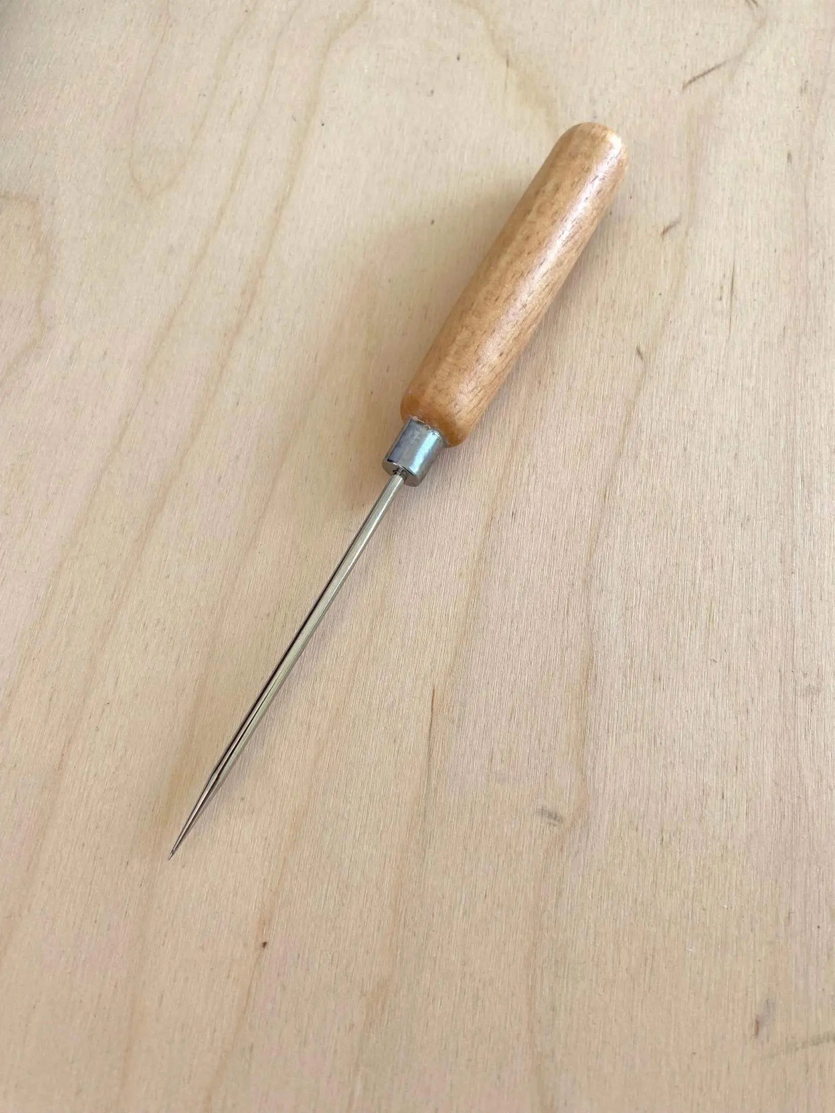 Long Handle Leather Scratch Awl on light wooden surface.
