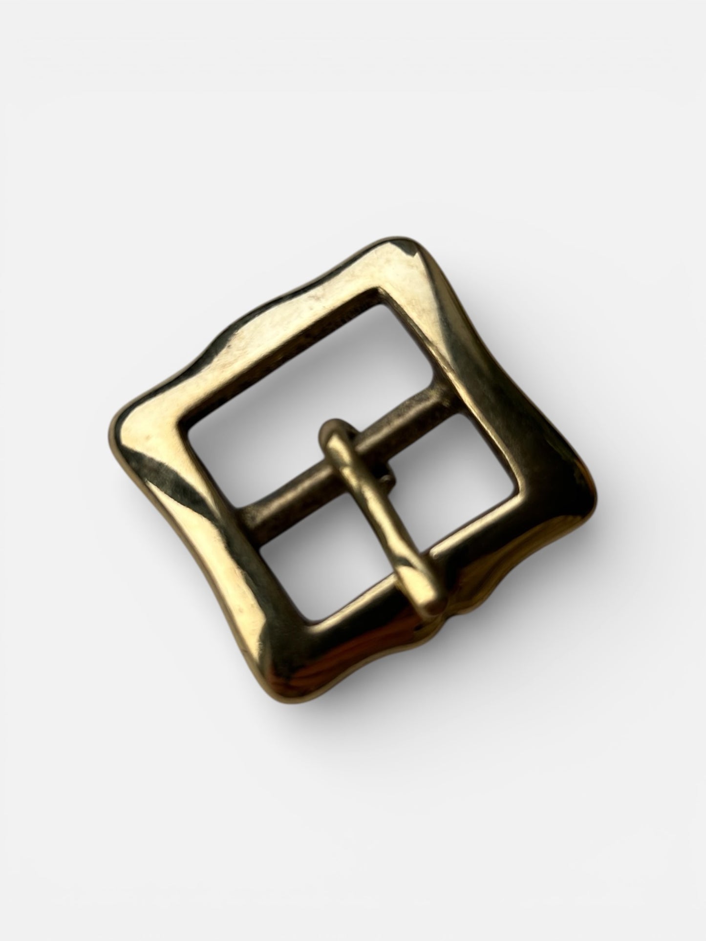 Gold metal buckle on a white background
