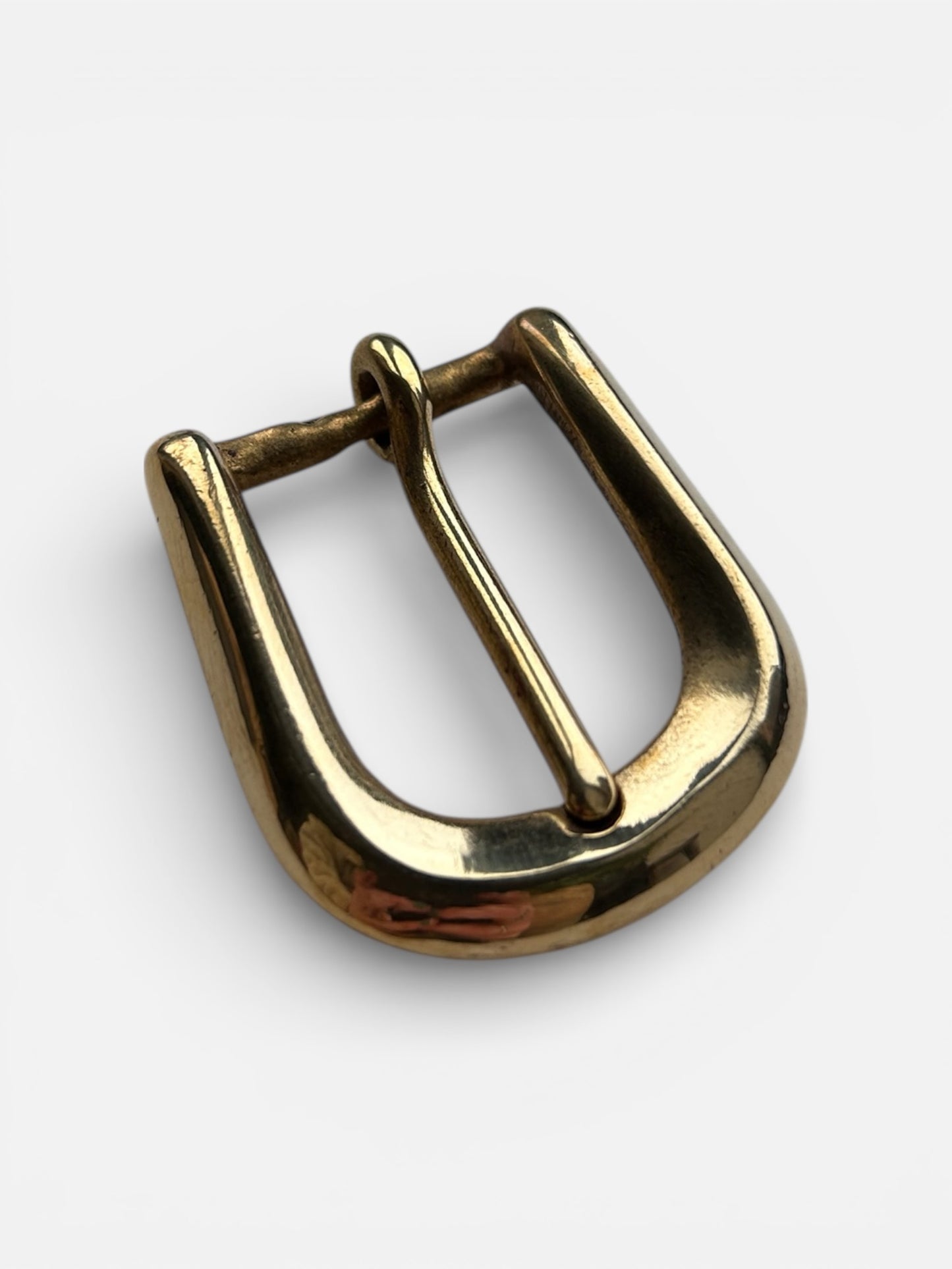 Gold metal buckle on a white background