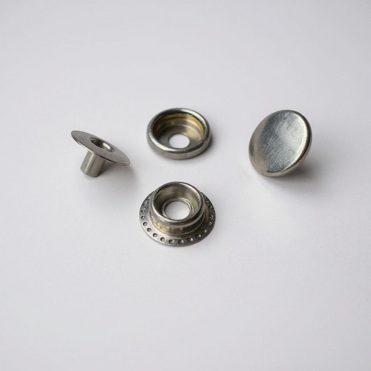 Four silver metal fasteners on a white background