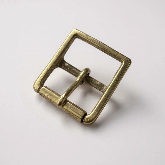 Brass belt buckle on a white background