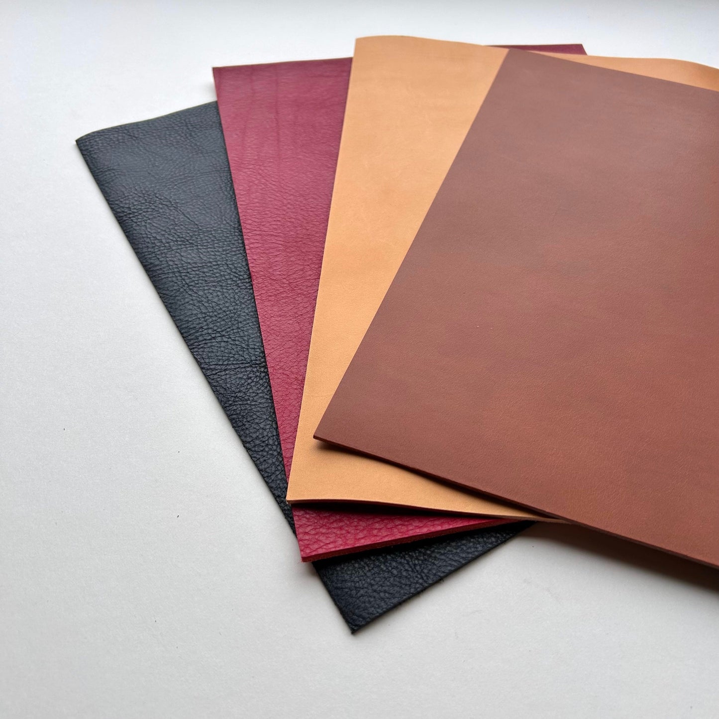 Set of leather panels in various colours on a white background