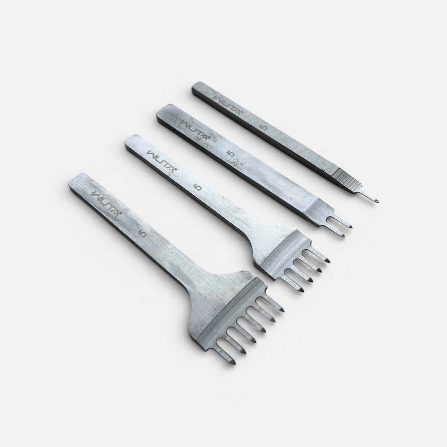 Set of metal WUTA diamond leather punch tools on a white background