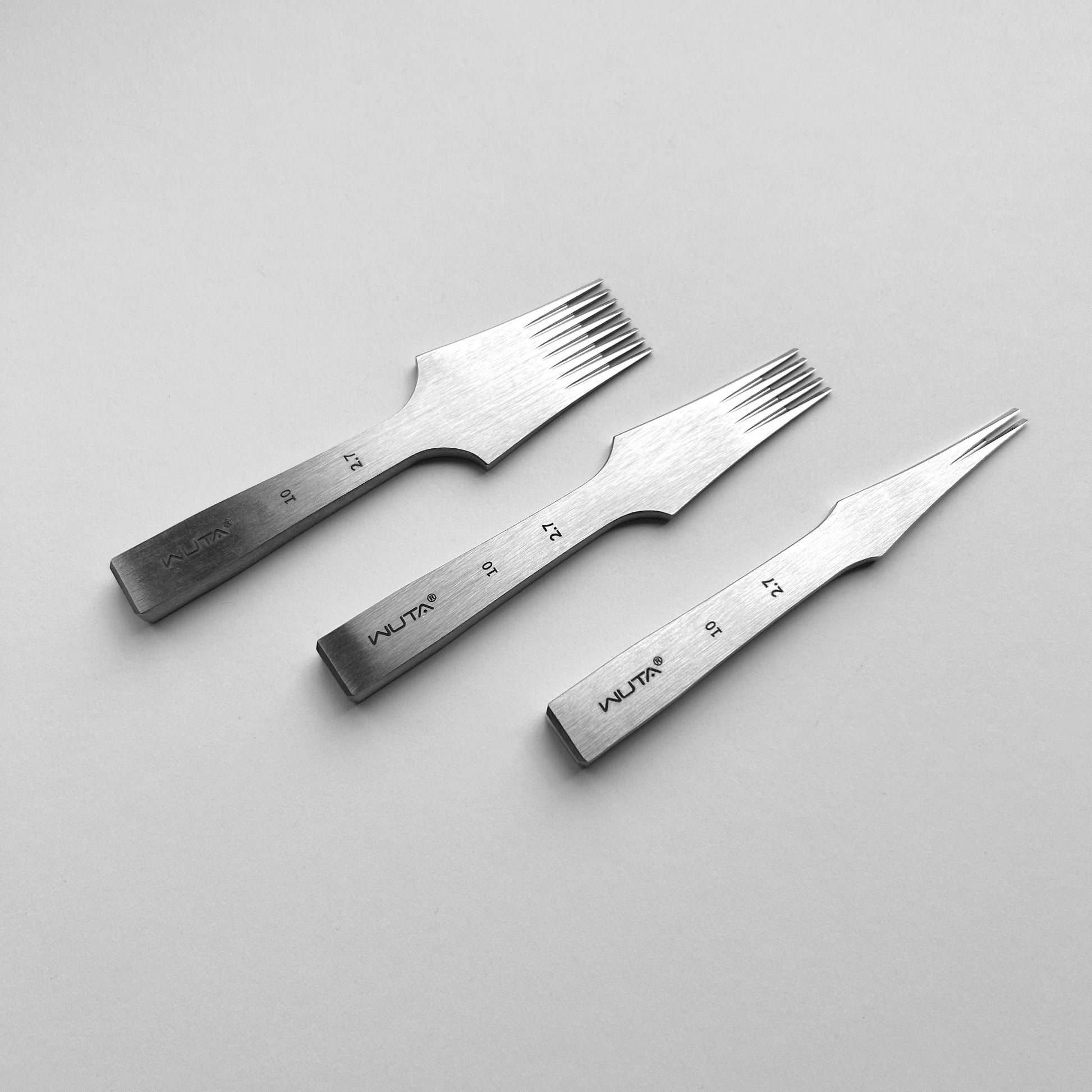 Three metal leather pricking irons with 'WUTA' branding on a gray background