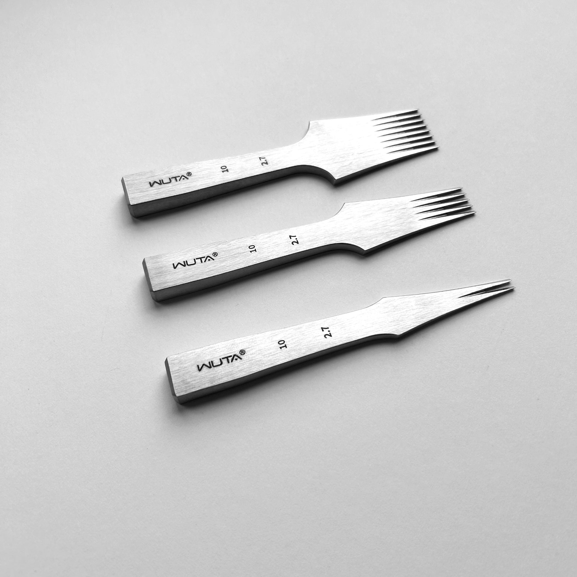 Three metal leather stitching punches with 'WUTA' branding on a gray background