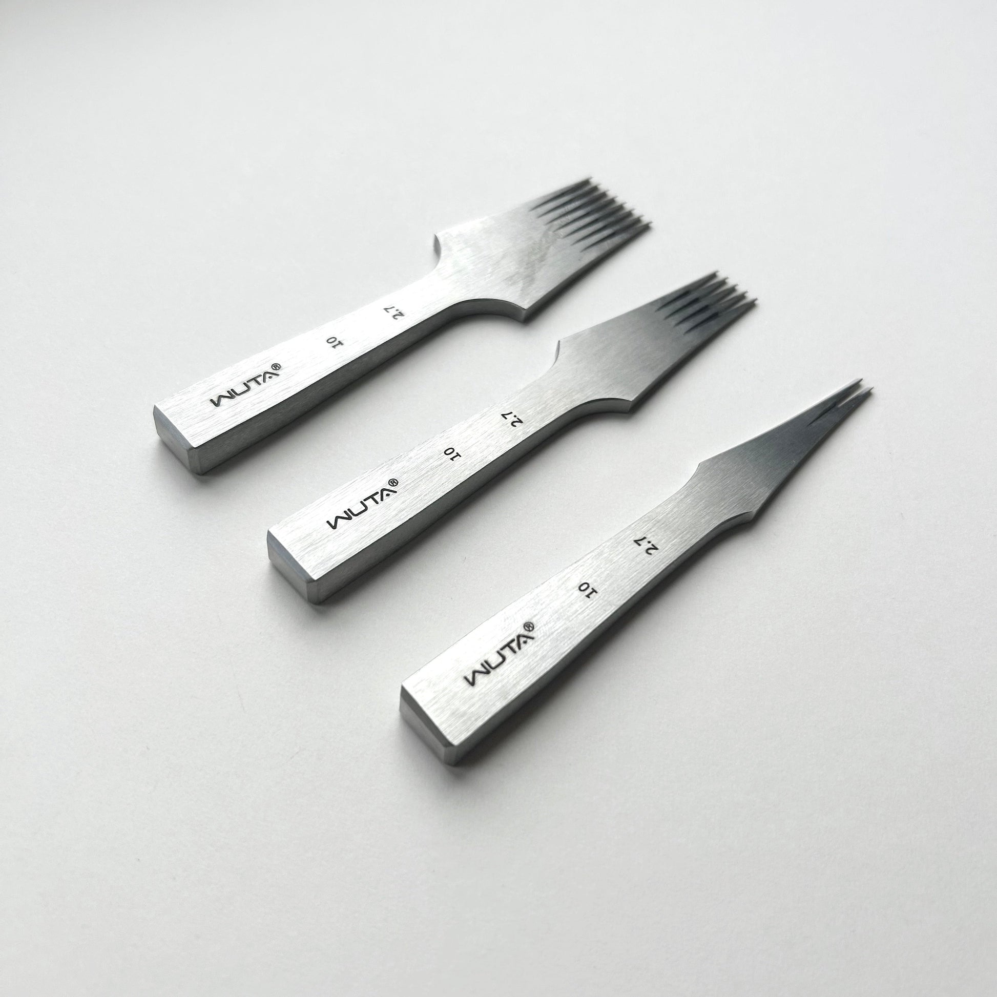 Three metal leather stitching punches with 'WUTA' branding on a light gray background