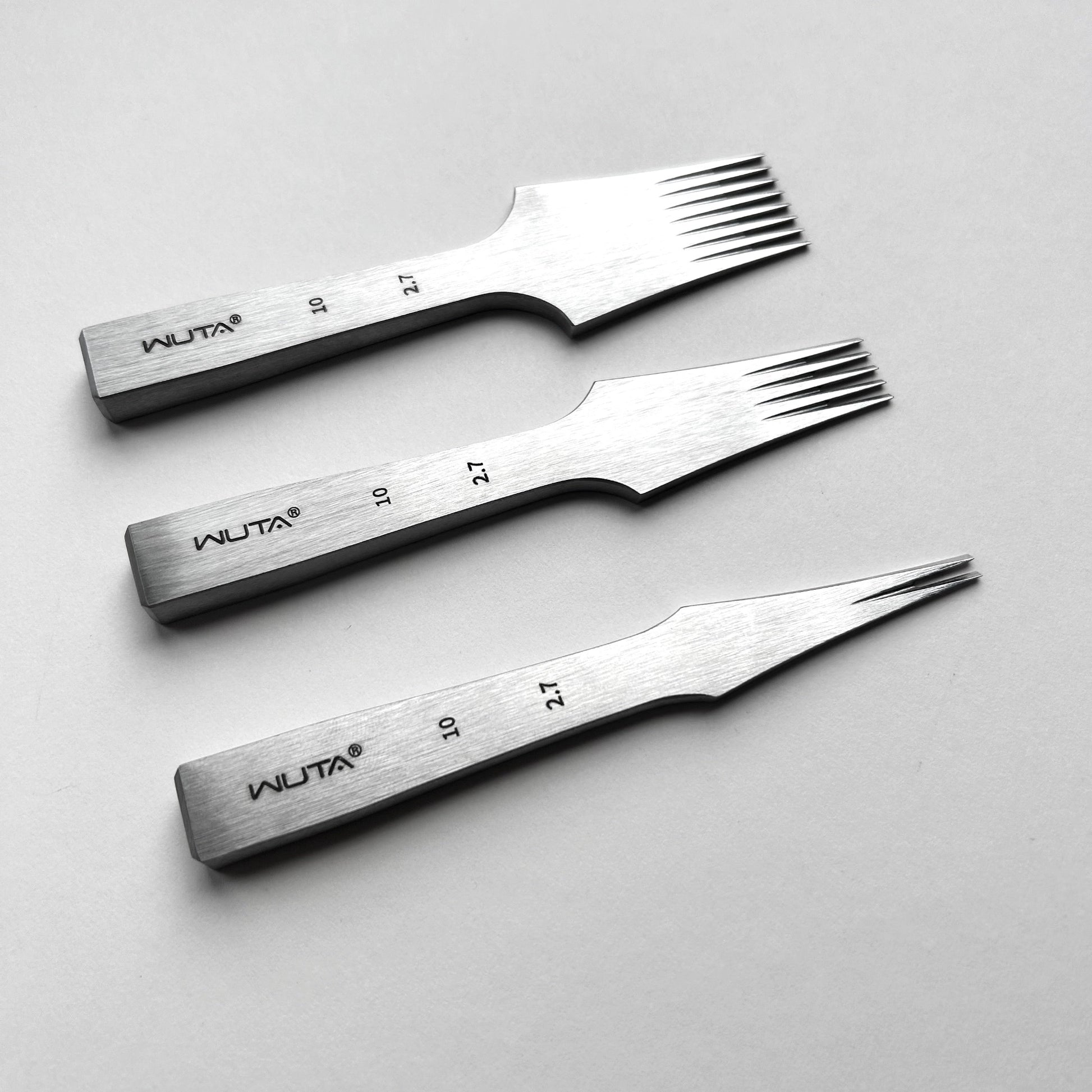 Three metal tools with WUTA branding on a light gray background