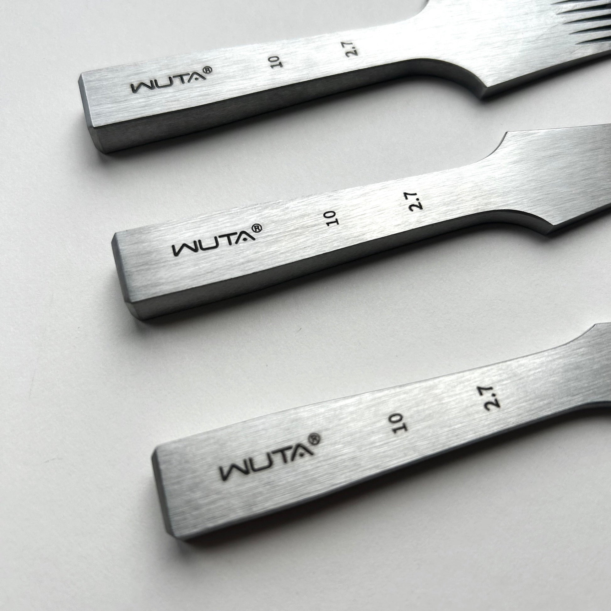 Three leather pricking iron tools with 'WUTA' branding on a light gray background