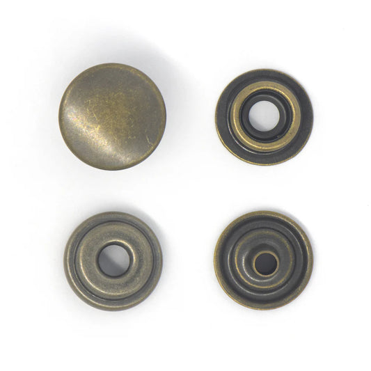 Four metallic buttons with a brass finish on a white background