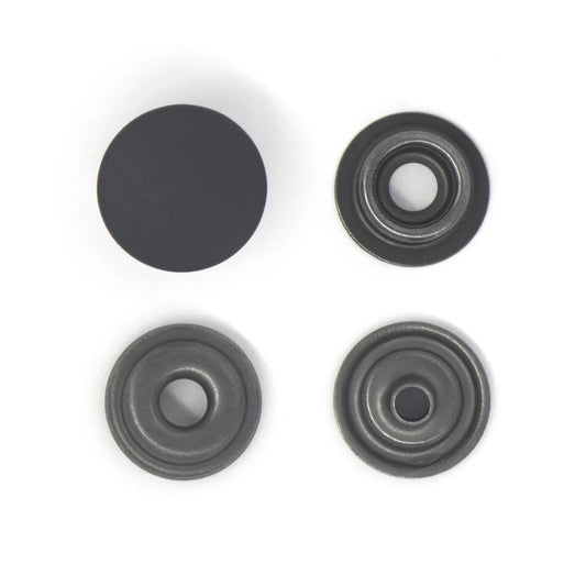 Four black popper snaps on a white background