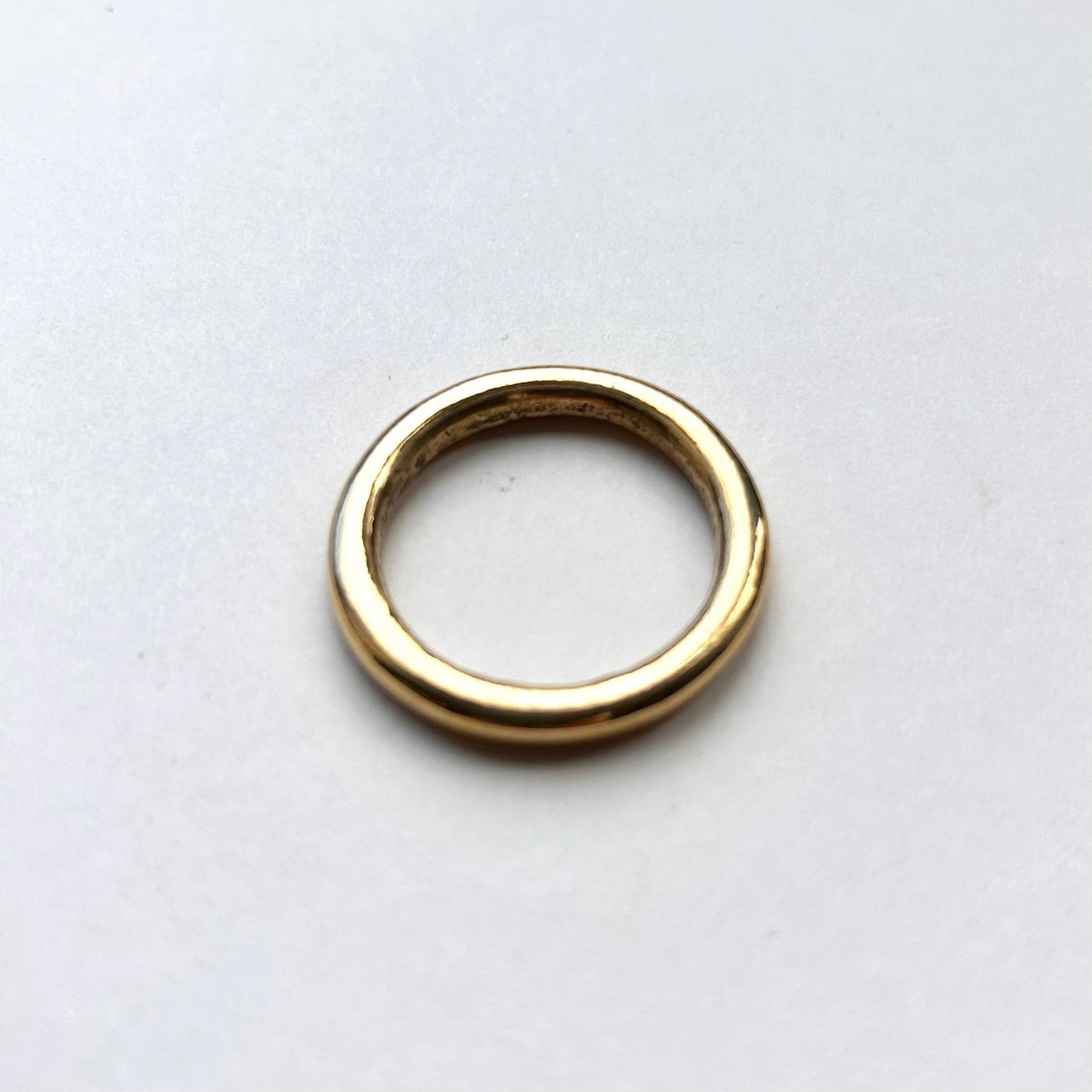 Gold solid brass o ring on a white background