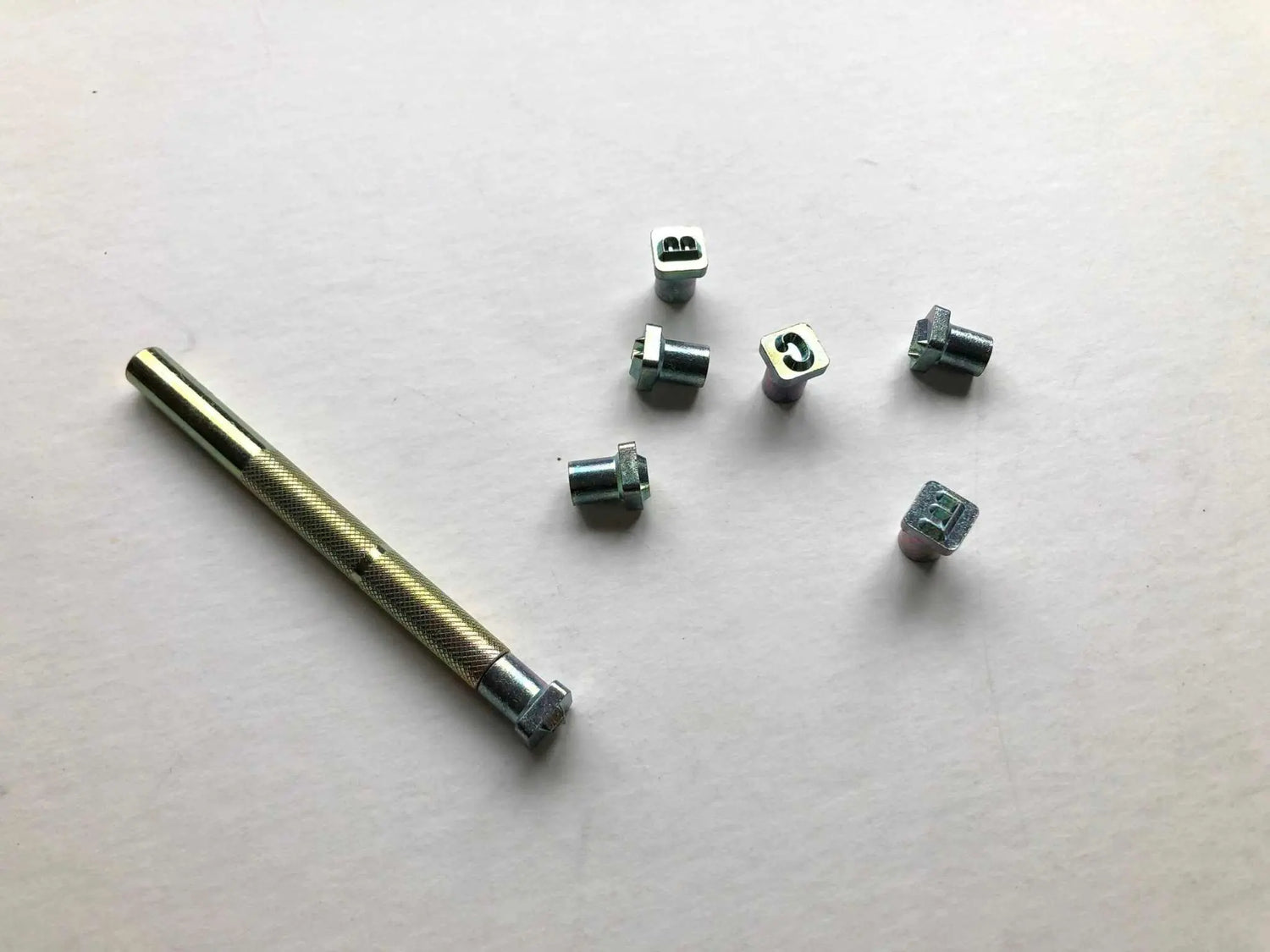 Leather embossing alphabet stamps with a setting tool