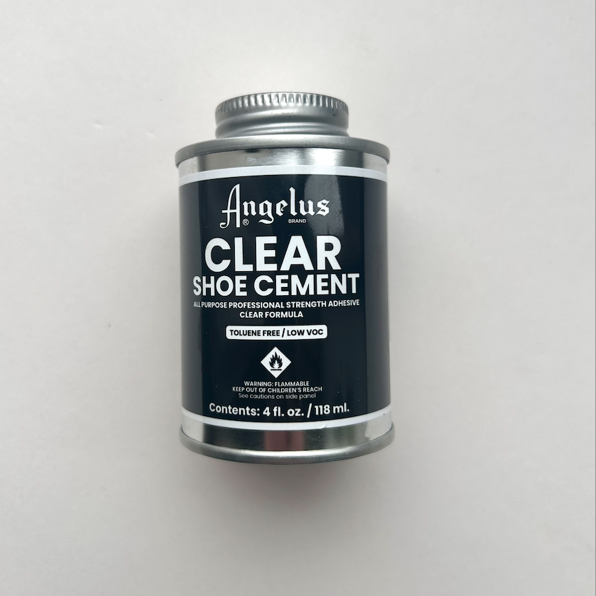 Can of Angelus Clear Shoe Cement on a light gray background