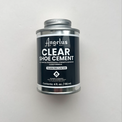 Can of Angelus Clear Shoe Cement on a light gray background